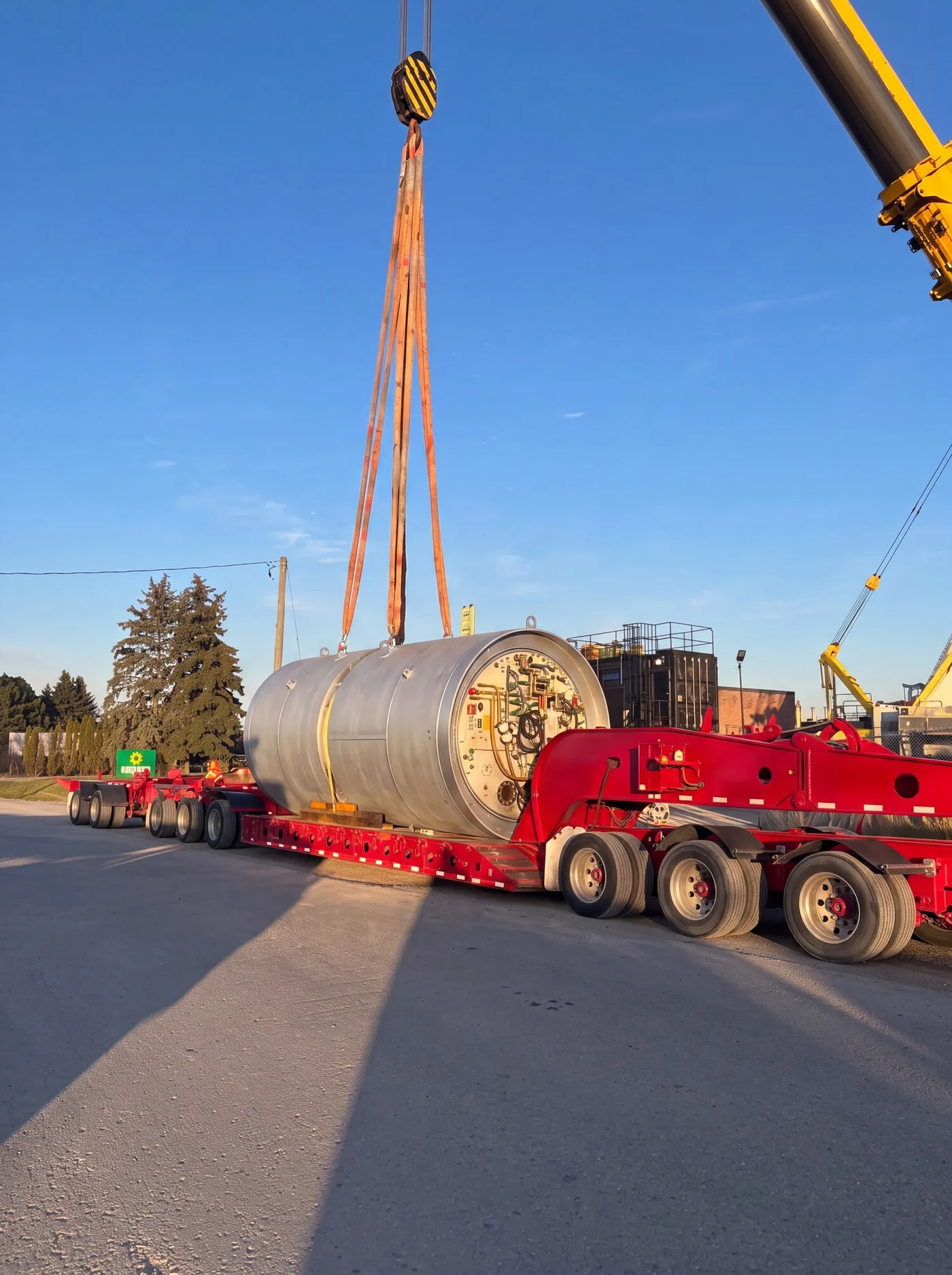 Tunnel boring machine section craned onto a multi-axle modular trailer