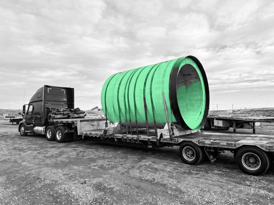 Erritt / Heidelberg precast concrete pipe on lowboy trailer pulled by red Peterbilt (winter)