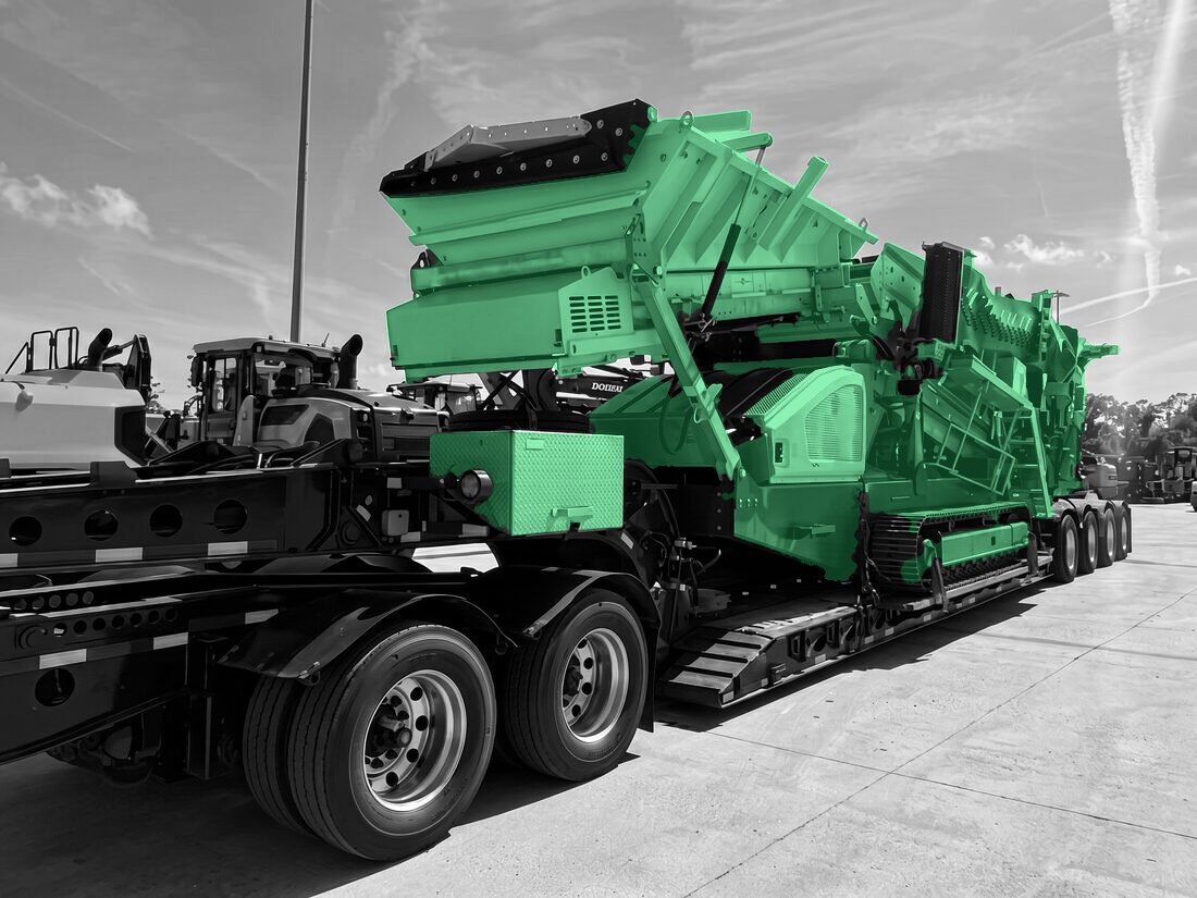 Metso tracked jaw crusher loaded on multi-axle lowboy with ramps deployed