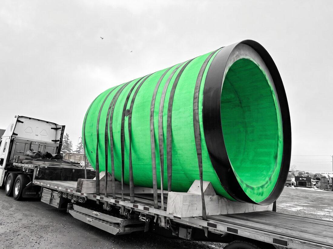 Heidelberg Materials / Erritt 7′ diameter precast concrete pipe section strapped on flatdeck — Calgary