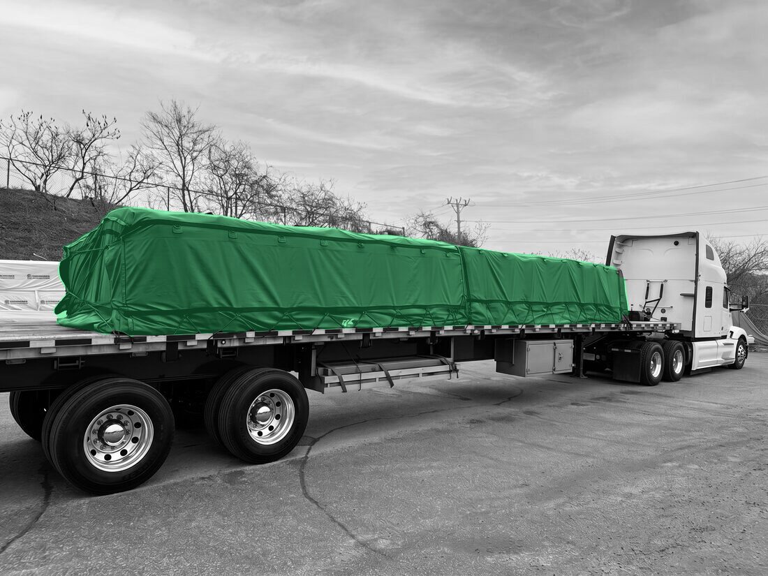 Same flatdeck after red tarp installed over bulk-bag load — Barrie ON depot