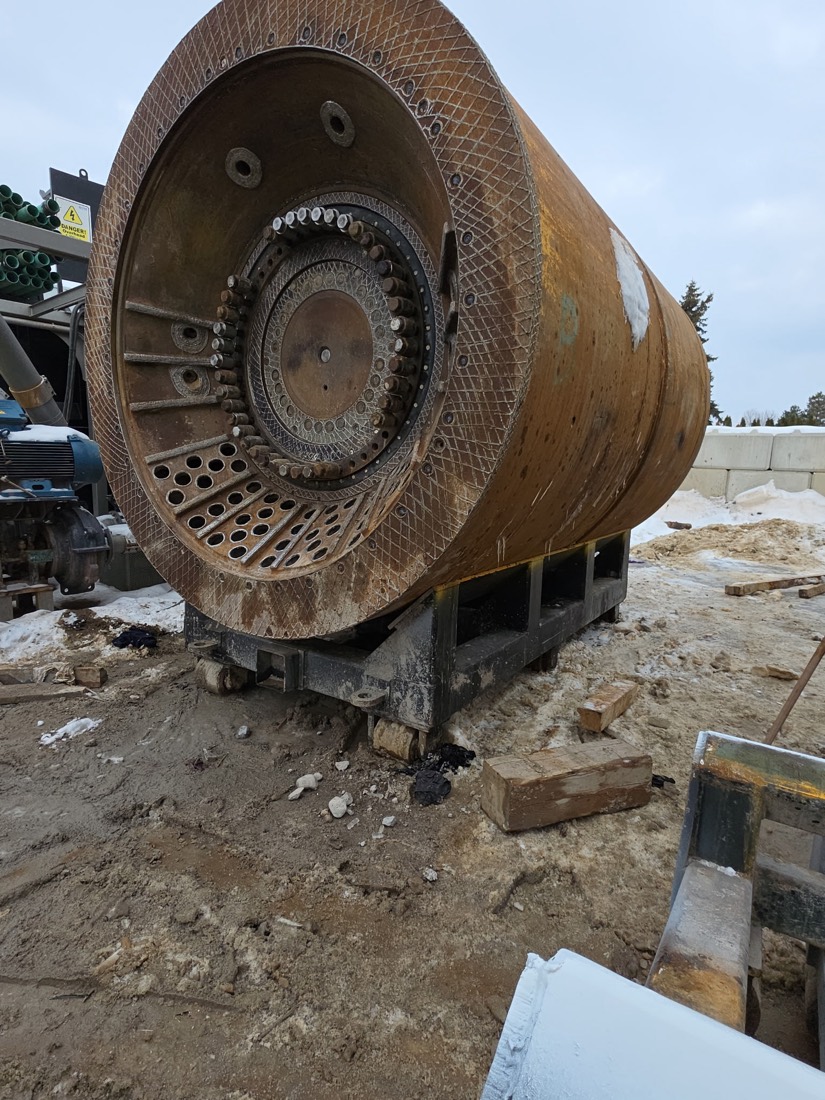 Used SAG / ball mill drum showing discharge grate and lifter bars, staged on cribbing
