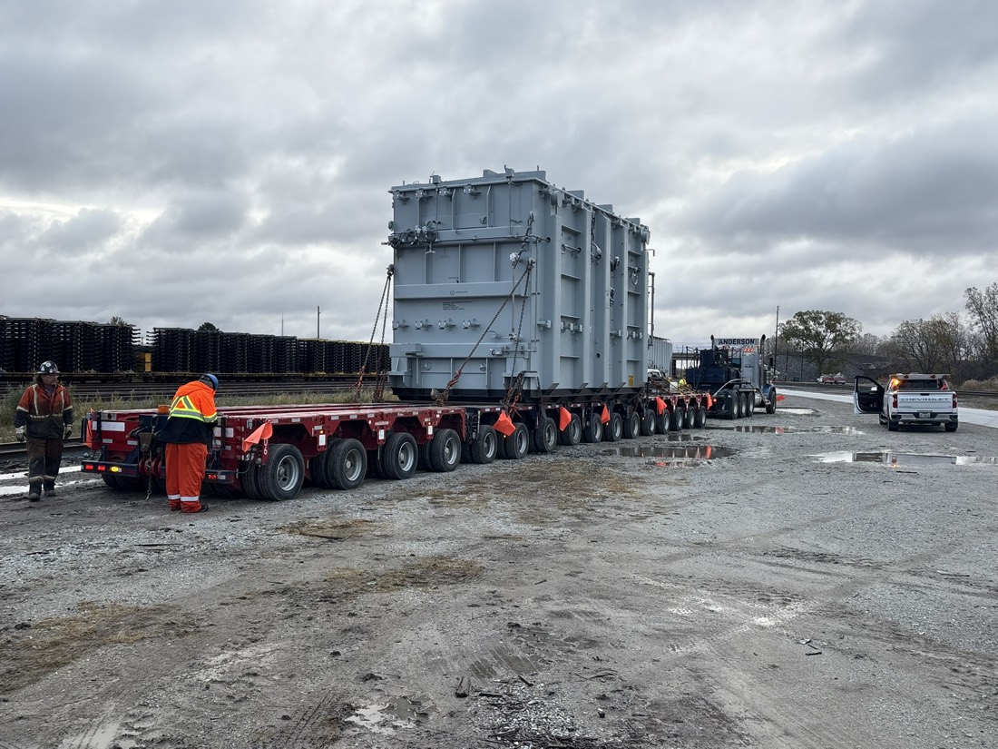 Large power transformer on multi-axle modular heavy-haul rig at rail-side yard