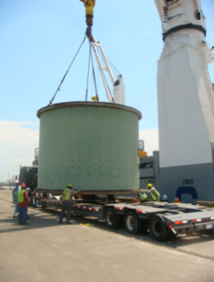 Green SAG/ball mill shell section being lowered onto modular trailer at port (duplicate of 11.png)