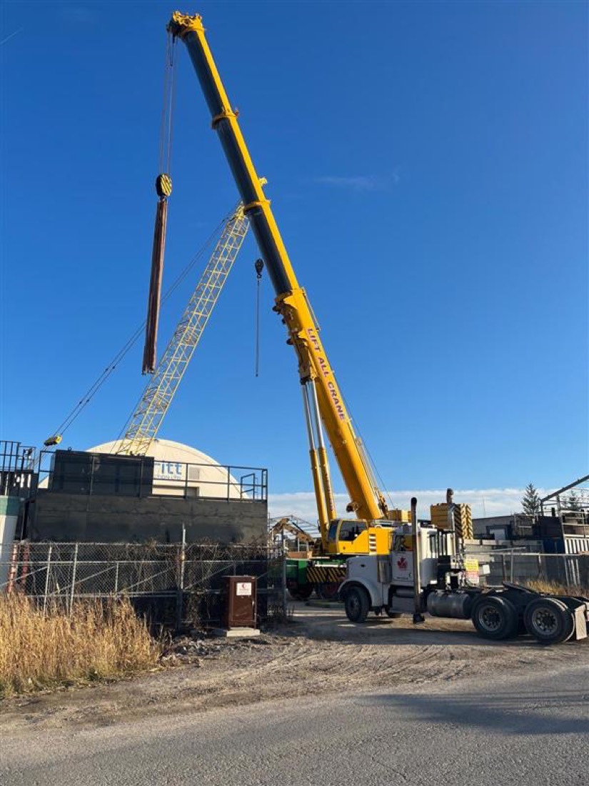 Lift-All Crane yellow telescopic mobile crane with boom extended at job site