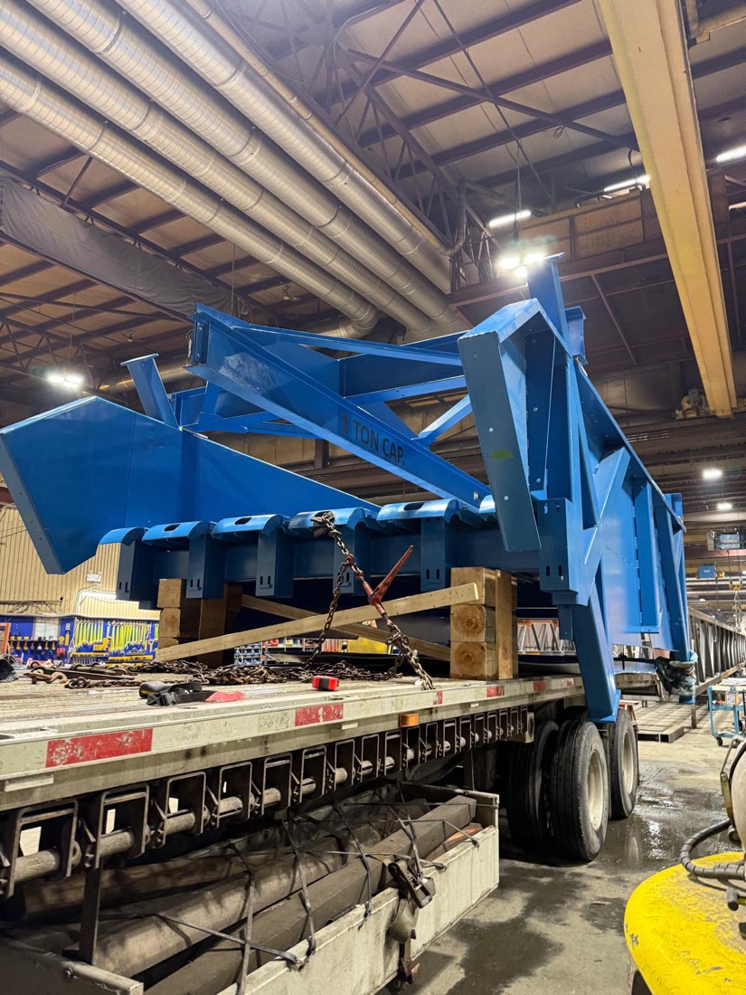 Blue structural steel hopper / feed chute for mining processing plant on flatbed in warehouse