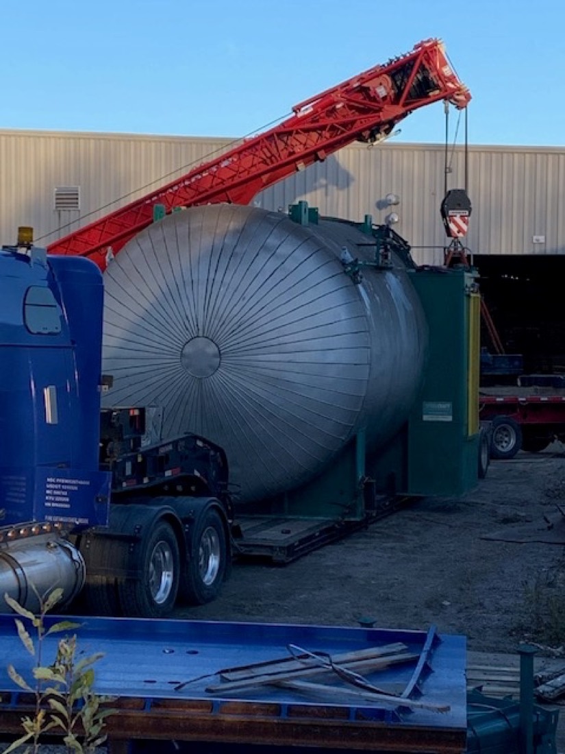 Stainless steel pressure vessel / process tank on lowboy trailer, red lattice crane lifting