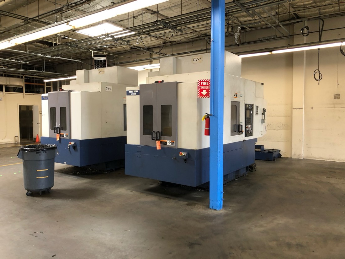 Two Mori Seiki GV-series CNC machining centers in machine shop (pre-rig)