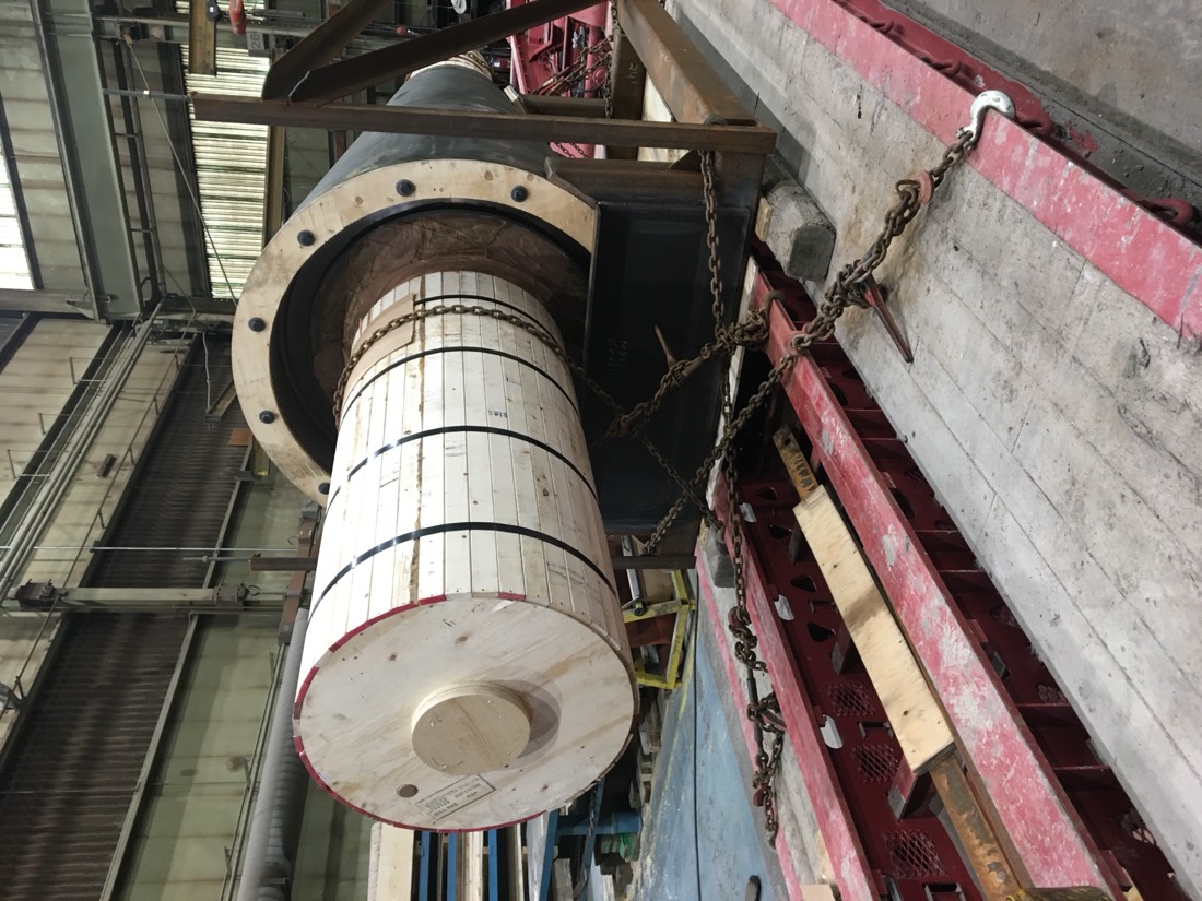 Large industrial drive shaft / mill trunnion roller in wooden crate on flatbed in shop