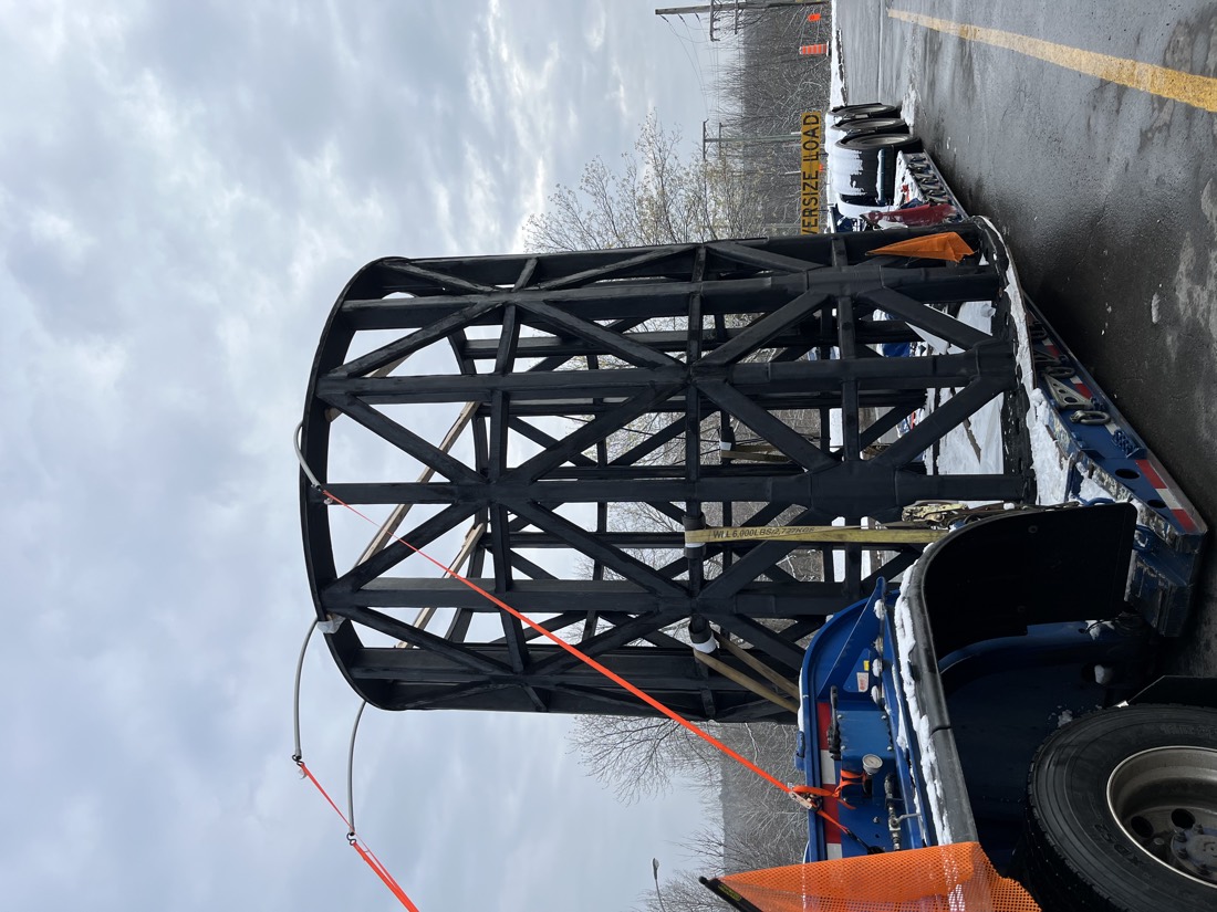 Black tubular steel cage / cylindrical lattice frame on OVERSIZE LOAD lowboy