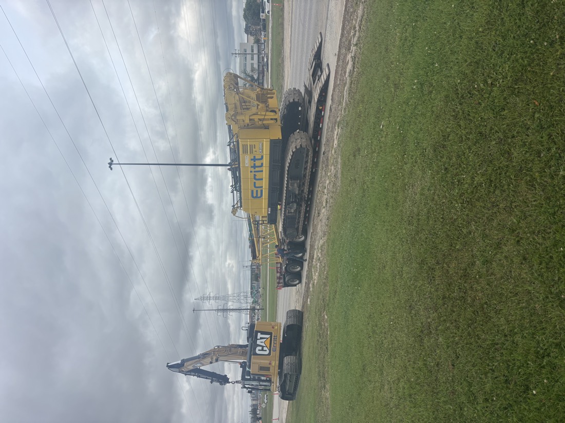 Multiple Cat (Erritt) crawler cranes lined up at job site