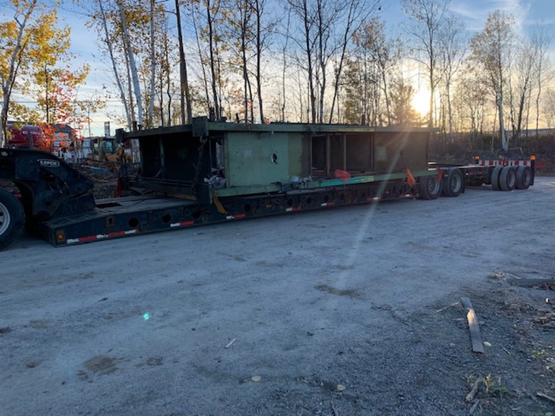 Green industrial process module / housing on Aspen multi-axle lowboy at sunset