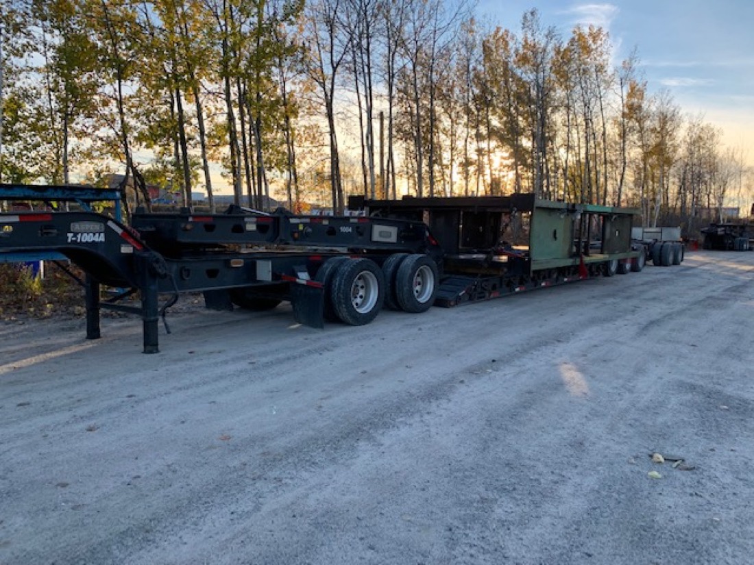 Aspen T-1004A lowboy with green industrial module — full view at sunset
