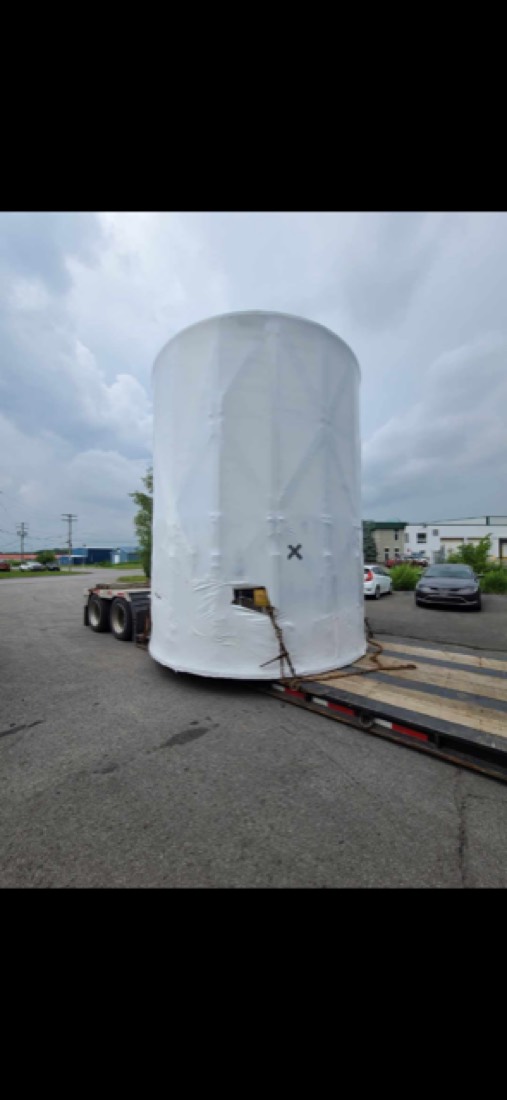 Same large white tank on flatbed (thumbnail) — different angle