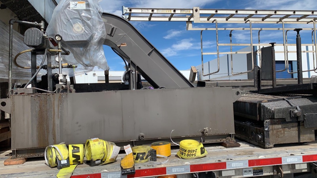 CNC machining center bed with chip conveyor on flatbed (Mori Seiki / similar)