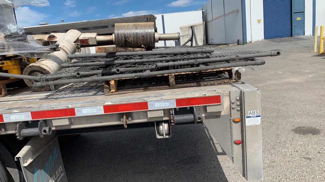 Drill rods / oilfield drill pipe string on Wilson Trailer flatbed