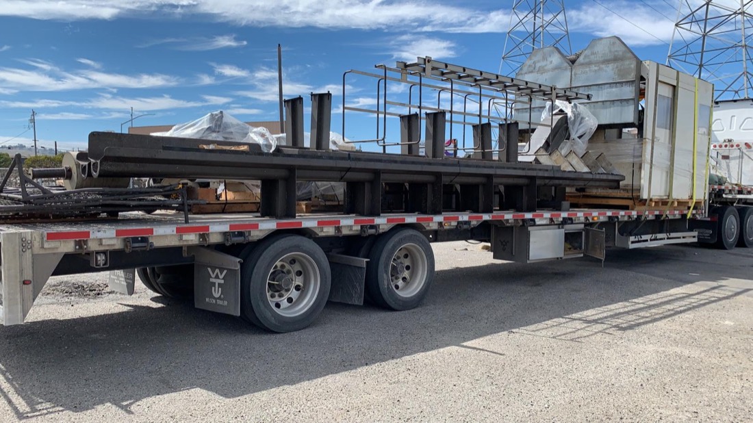 Drill pipe / oilfield drill rods arranged in racks on Wilson Trailer flatbed