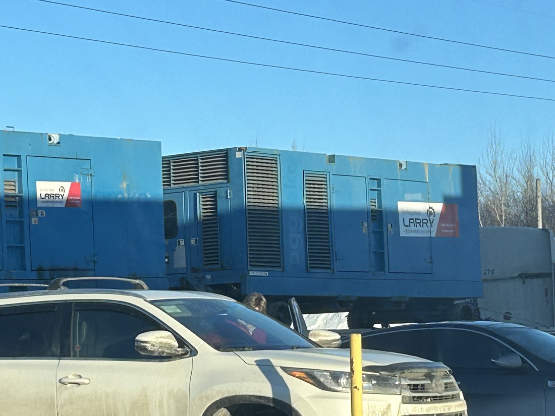 Two blue Larry Transport diesel generator sets / power packs at yard