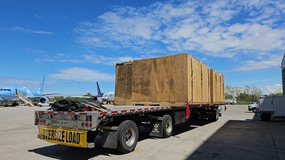 CARGOJET wooden tooling shipping crate on OVERSIZE LOAD step-deck flatbed at airport