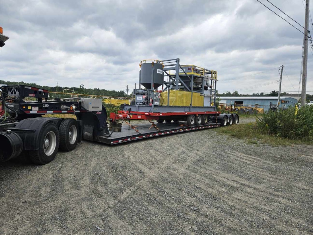 Mining mill processing skid (hopper / feeder / conveyor) on Aspen lowboy at equipment yard
