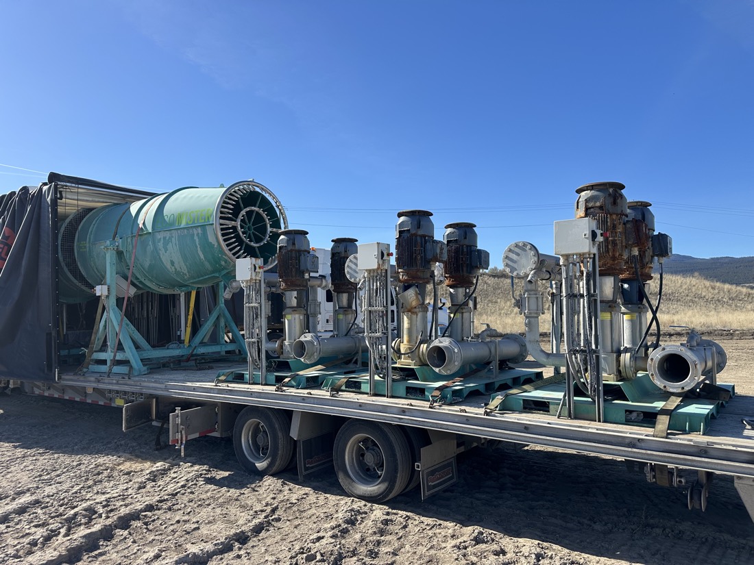 EcoMister dust cannons + vertical pump skids on Conestoga flatbed at mining site (different angle)