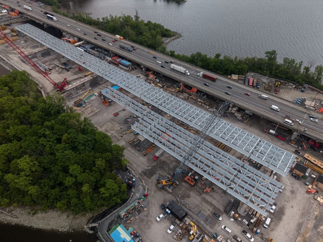 Aerial view of bridge truss sections being staged at Île-aux-Tourtes construction site