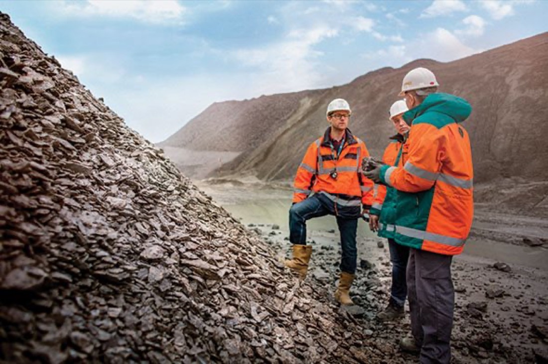 Metso stock photo — engineers inspecting crushed aggregate stockpile at quarry