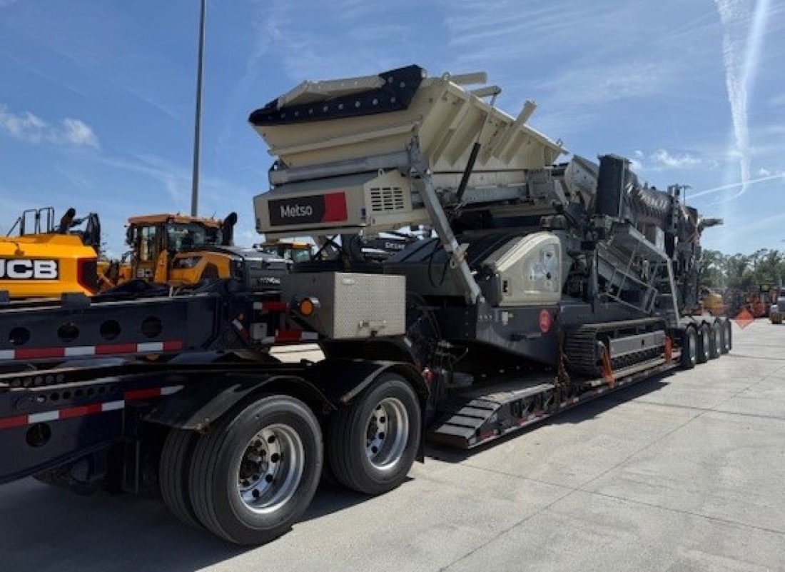 Metso tracked jaw crusher loaded on multi-axle lowboy with ramps deployed