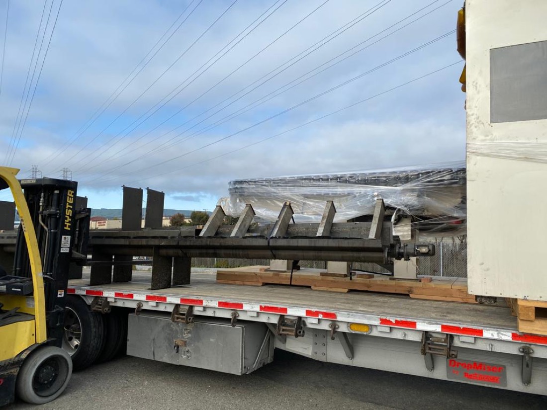 CBS Parts shipment — conveyor stands and idler frames staged on stepdeck for tie-down