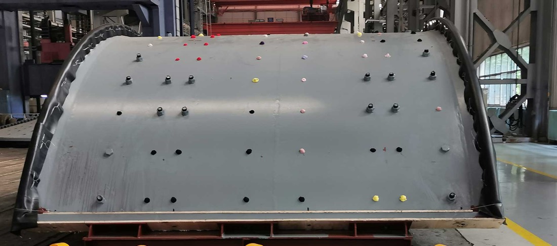 SAG mill shell quarter-segment on cribbing at fabricator shop, ready for shipment