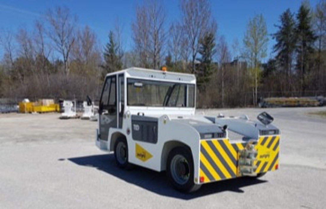 Small white airport pushback tug / ground-handling tractor staged for transport